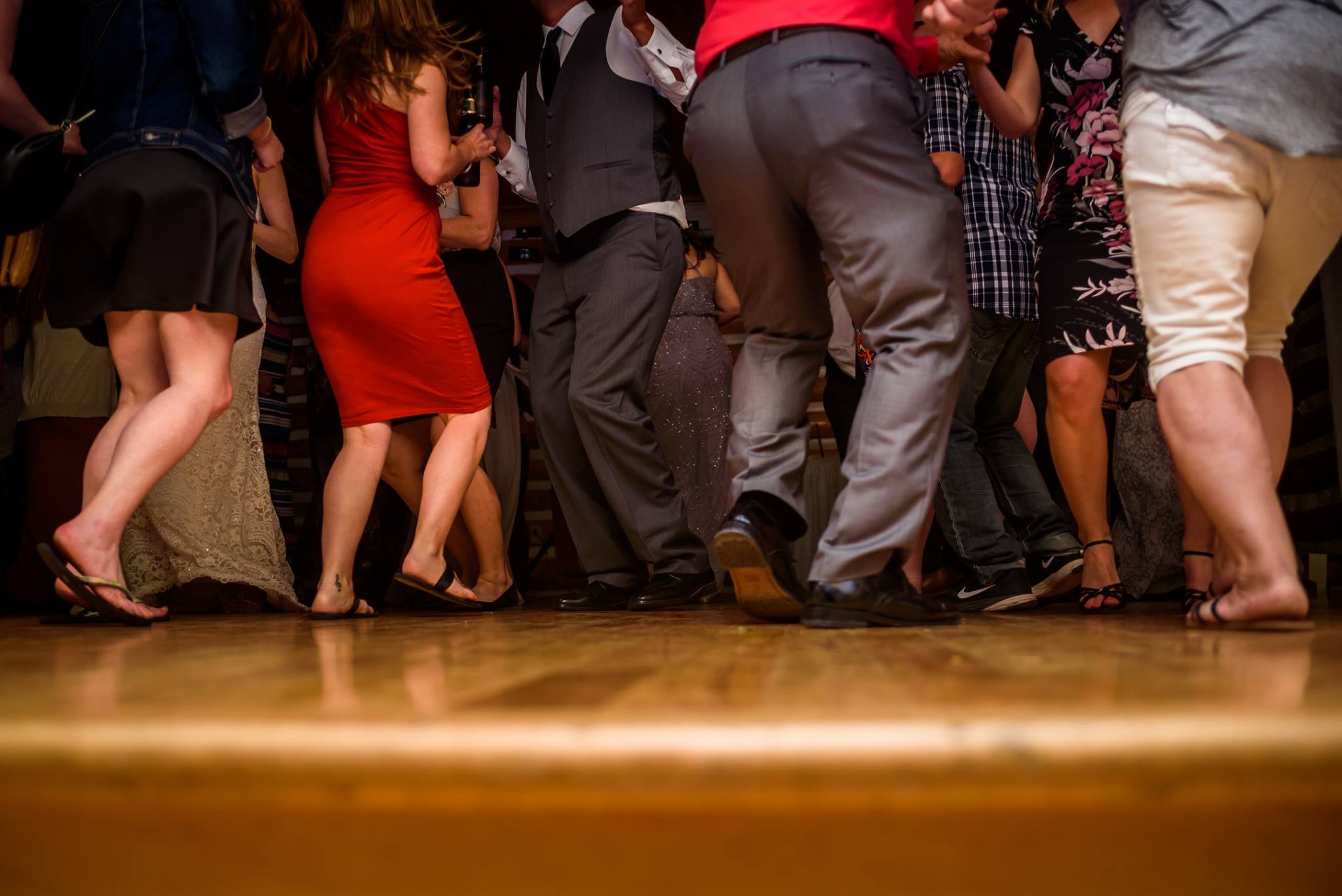Packed wedding dance floor with guests celebrating