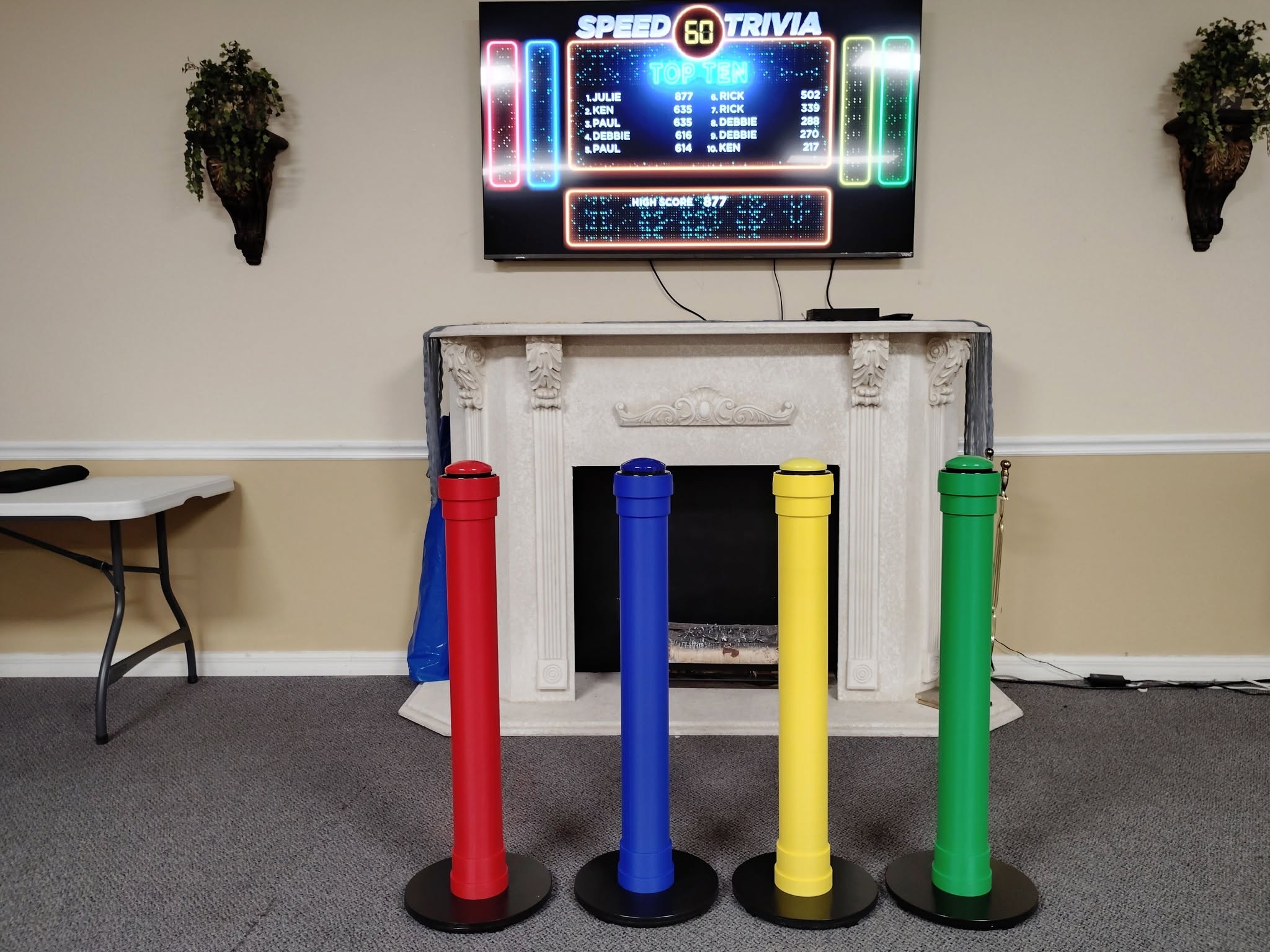 Think Fast Trivia setup with buzzers and scoreboard screen